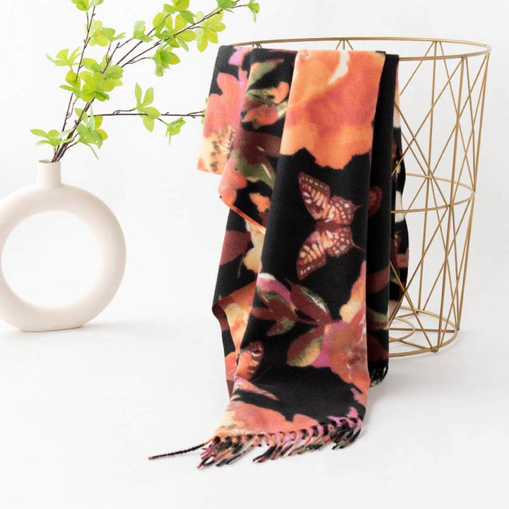 Accity | Retro Tassel Scarf | Abstract floral pattern in pink/orange against a black background.