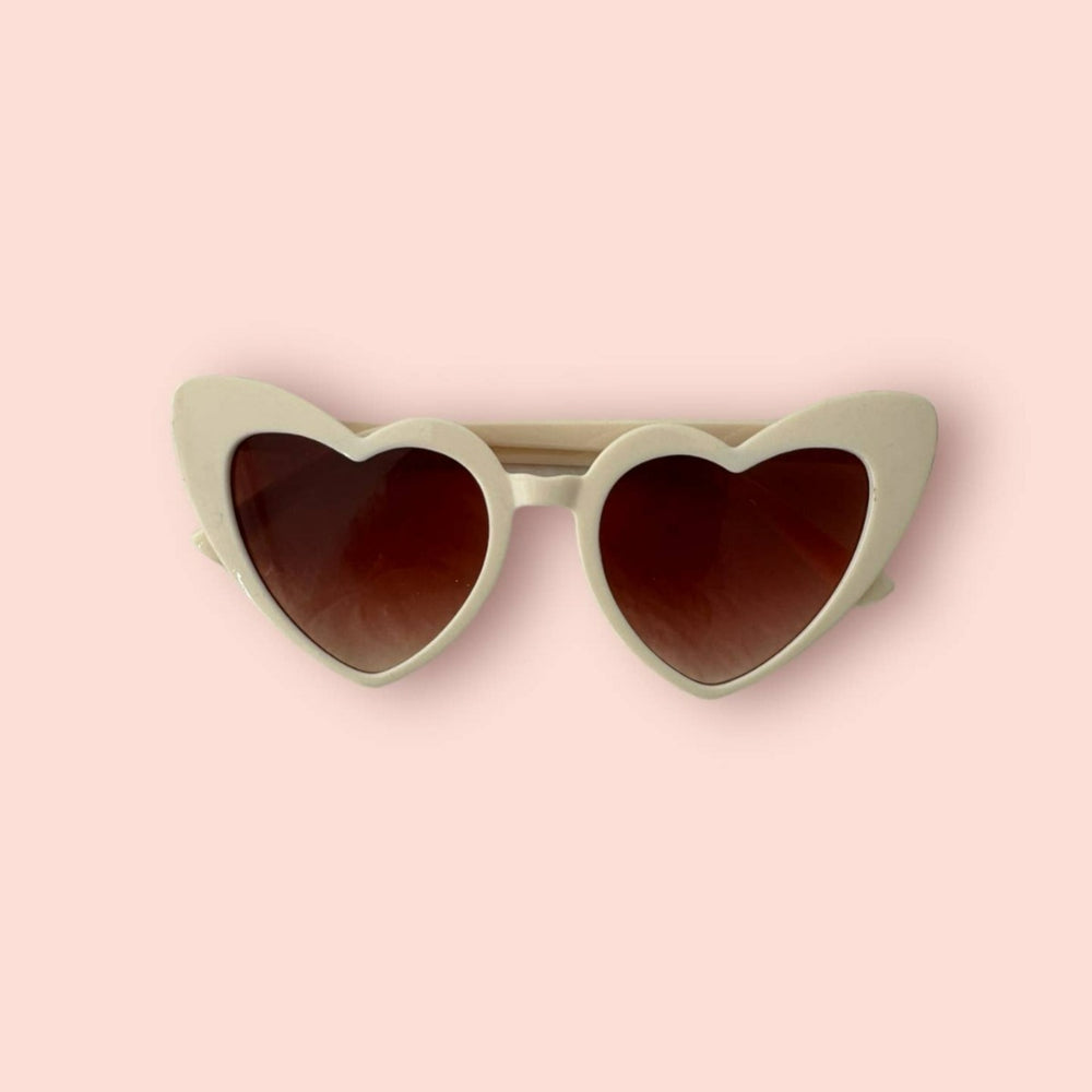 Close up on the white heart shaped glasses.