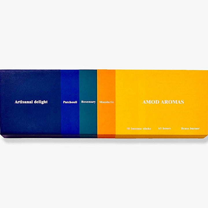 Amod | Artisanal Delight Incense | A colorful box with a blue to yellow gradiant. Patchouli, rosemary, mandarin. Comes with a brass burner.