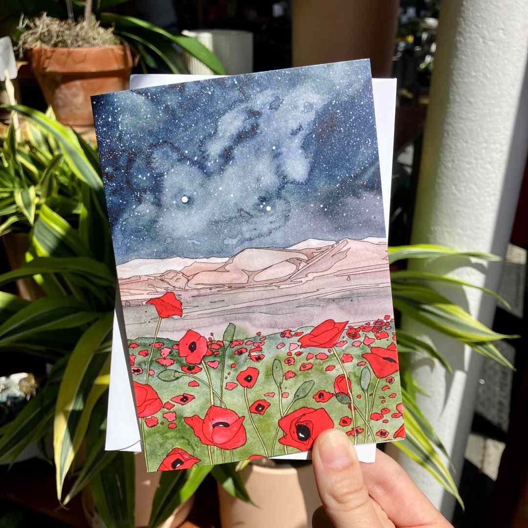 Andrea Durfee | Poppies | A field of poppies against a desert with a starry sky.