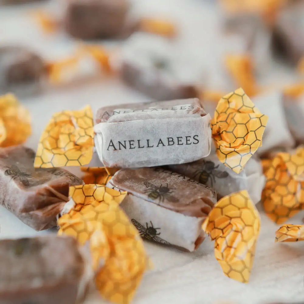 Anellabees chocolate bars with honeycomb design on a marble surface