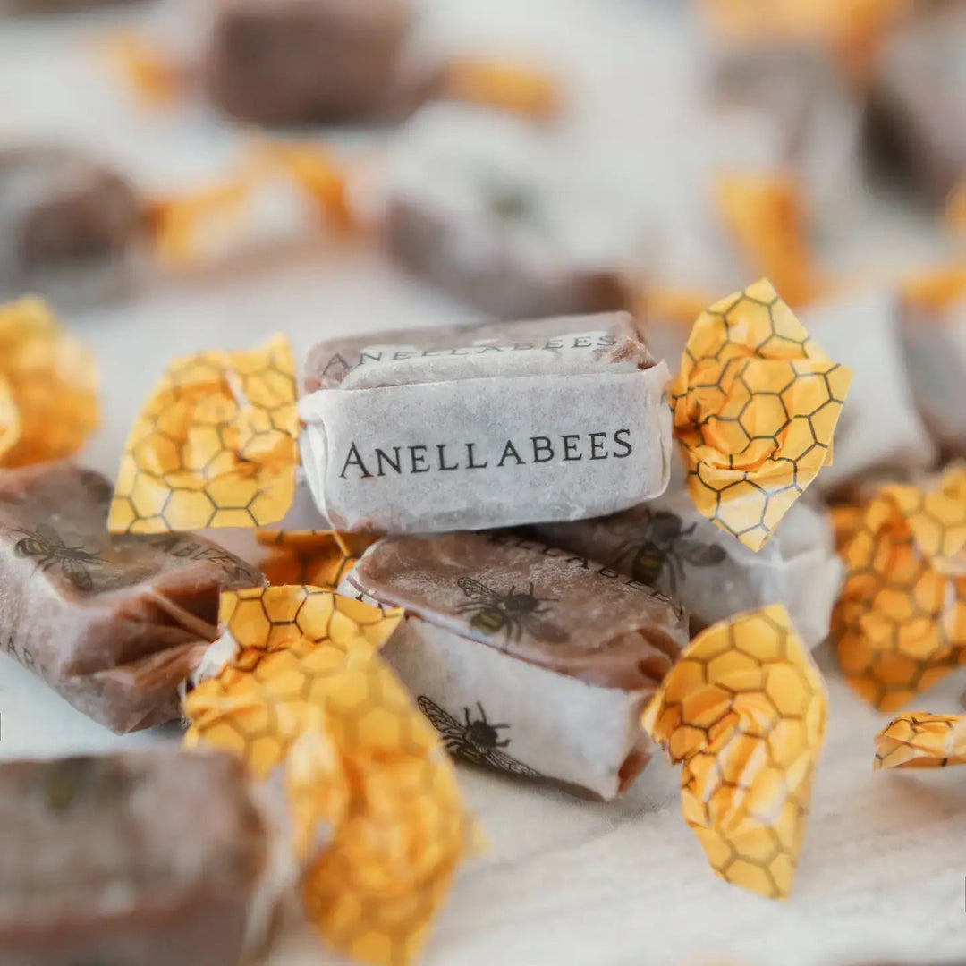 Anellabees chocolate bars with honeycomb design on a marble surface