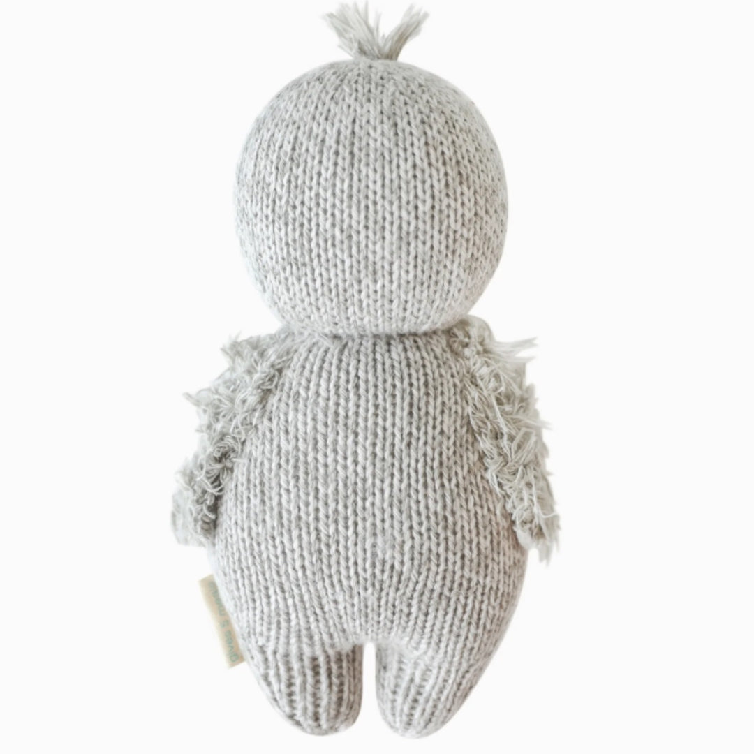 Baby Penguin | A light gray penguin, reverse side. Hand knit with fuzzy wings.