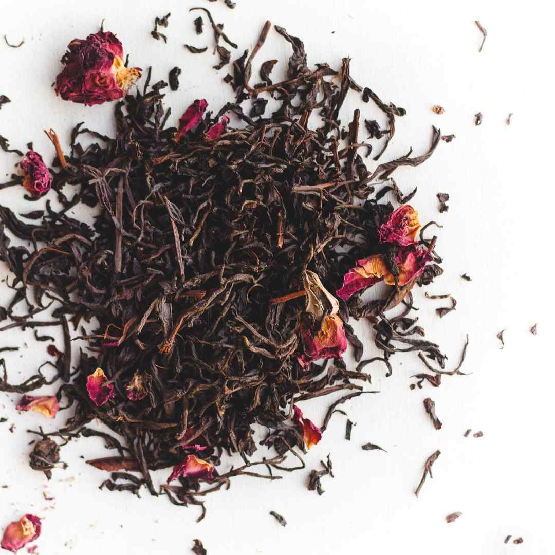 Big Heart Tea | Dry black tea leaves with dried flowers on a white background
