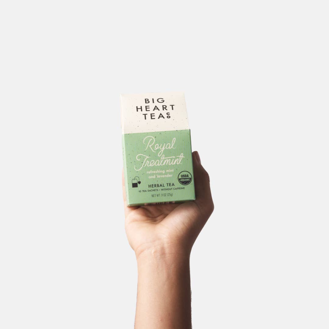 Big Heart Tea | Royal Treatmint | Hand holding a box of Big Heart Teas Royal Fennel Mint tea against a white background