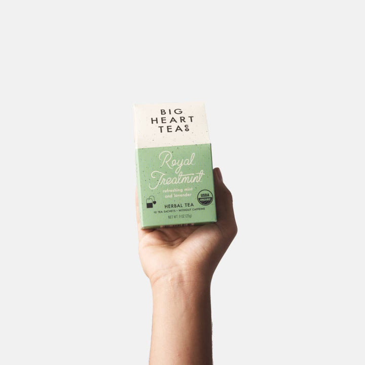 Big Heart Tea | Royal Treatmint | Hand holding a box of Big Heart Teas Royal Fennel Mint tea against a white background