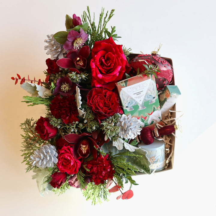Peppermint Swirl Gift Box with flowers blooms and chocolates, Flower arrangement in reds, greens, and accented with silver.