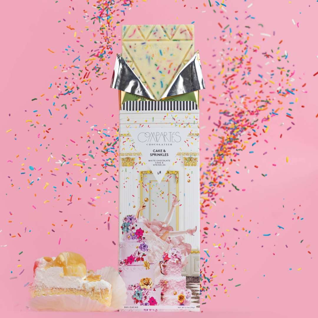 Compartes | Cake and Sprinkles | Chocolate packaging with a cake design on a pink background with sprinkles