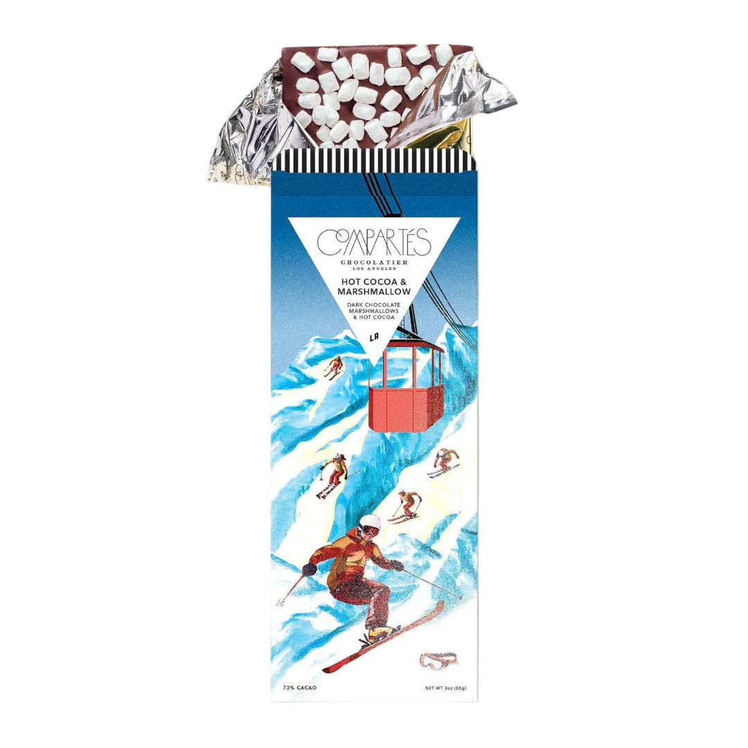 Hot cocoa and marshmallow package with skiing design on a white background