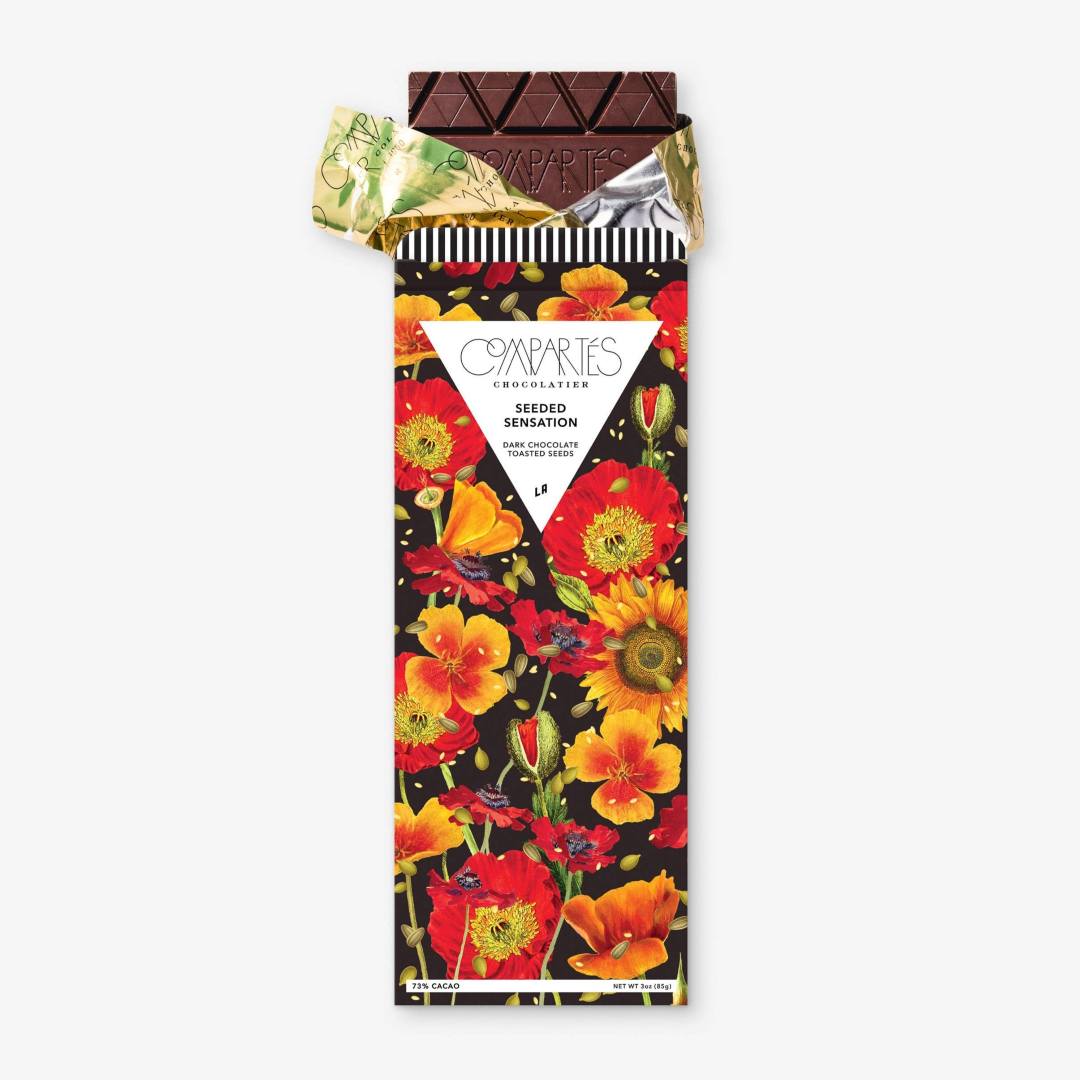 Compartes | Seeded Sensation | Chocolate bar with floral packaging on a white background