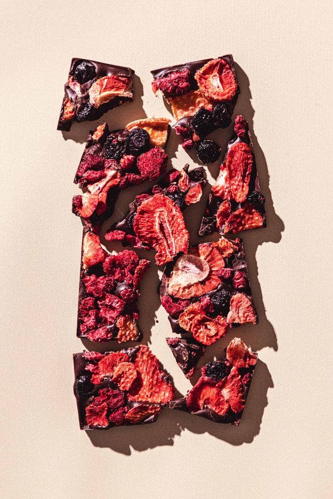 Compartes Chocolate | California Berries Dark Chocolate Bar | Shot of the bar with dehydrated strawberries and blueberries.