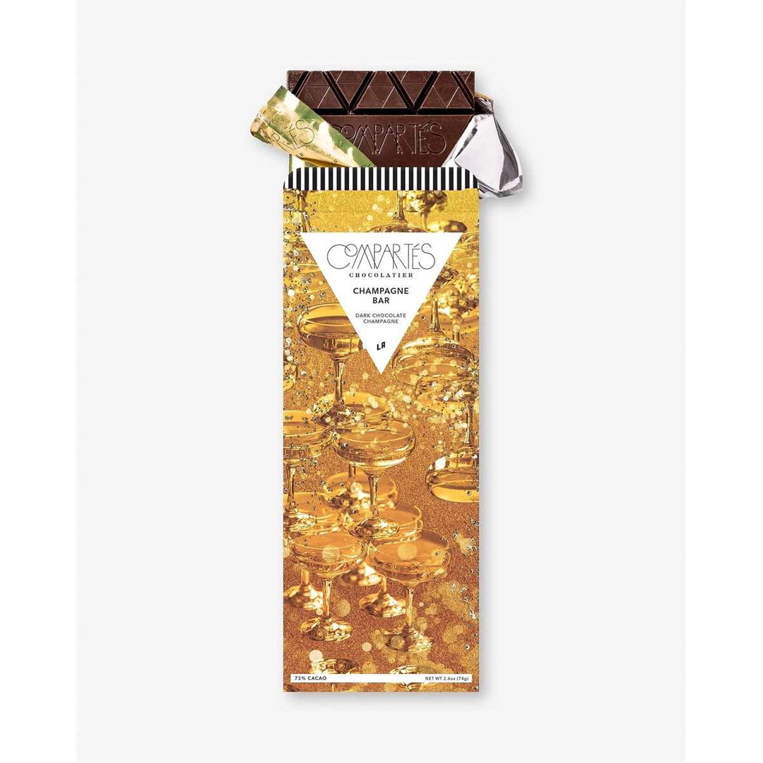 Champagne Dark Chocolate Bar | Compartes Chocolate | A shimmering gold package covered in bubbles and champagne glasses.