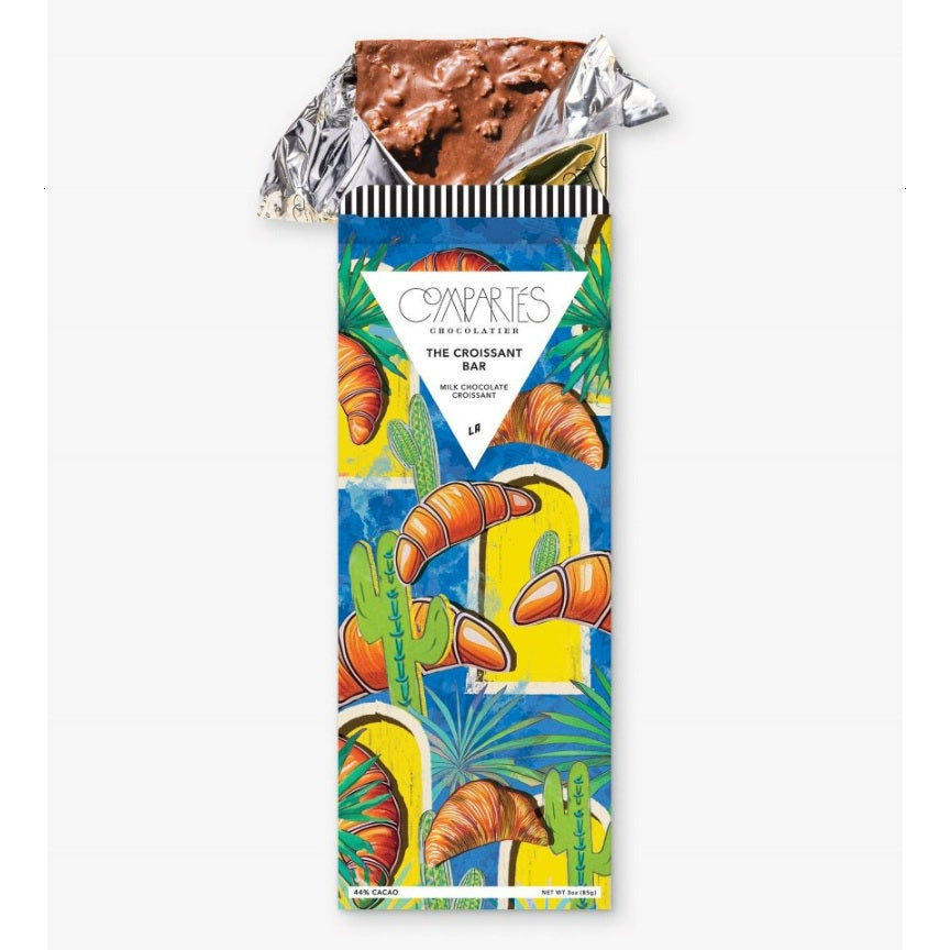 Compartes Chocolate | The Croissant Bar | A package with a blue background, yellow windows, and illustrated croissants.