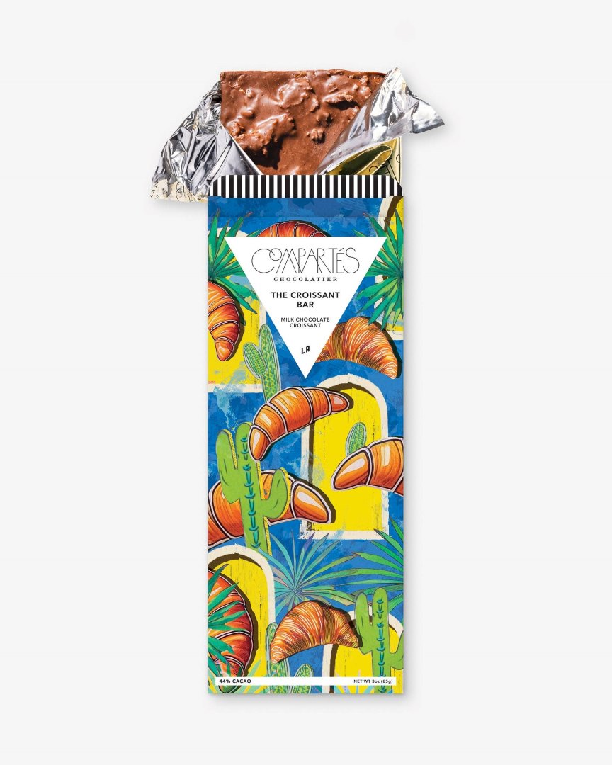 Compartes Chocolate | The Croissant Bar | A package with a blue background, yellow windows, and illustrated croissants.