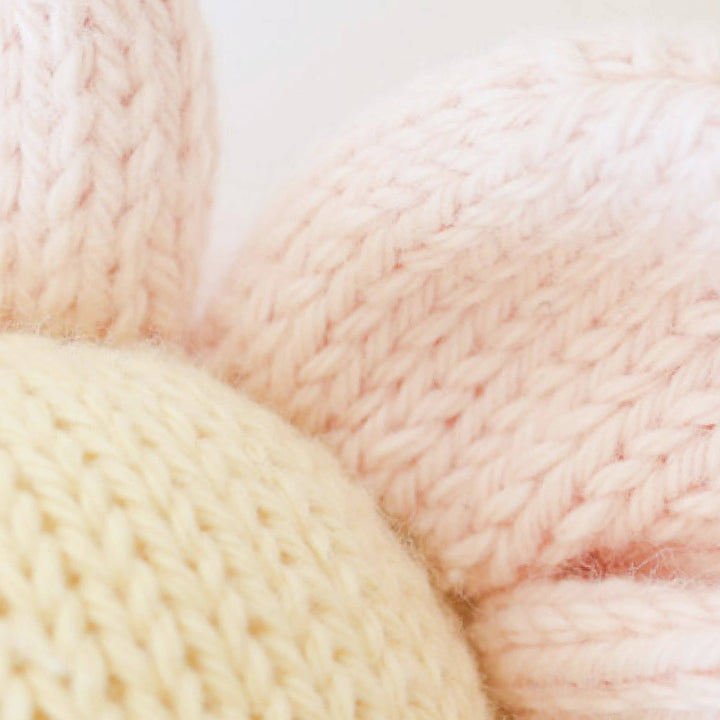 Close-up of pink and beige yarn balls