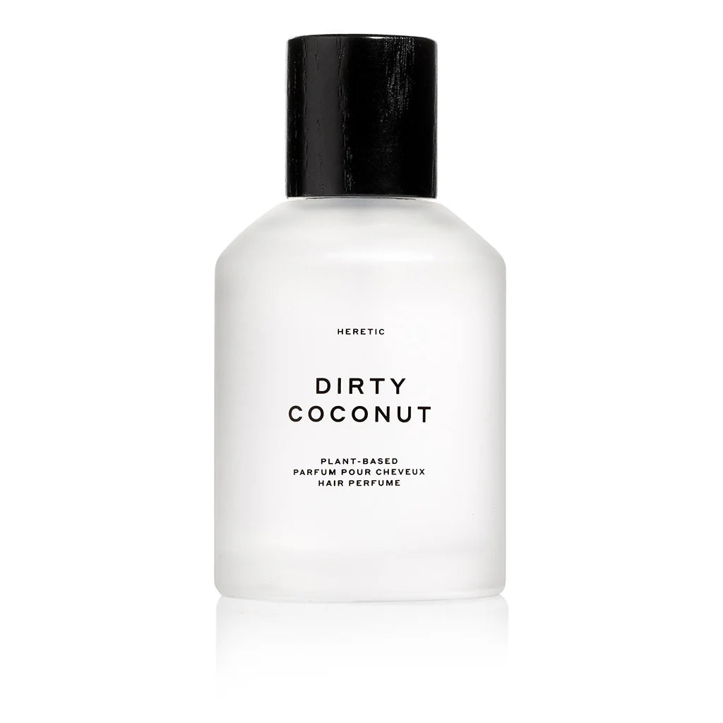 Heretic Parfum | Dirty Coconut Hair Perfume | A white frosted bottle with black accents. Text reads "Heretic, dirty coconut, plant-based, parfum pour cheveux, hair perfume.