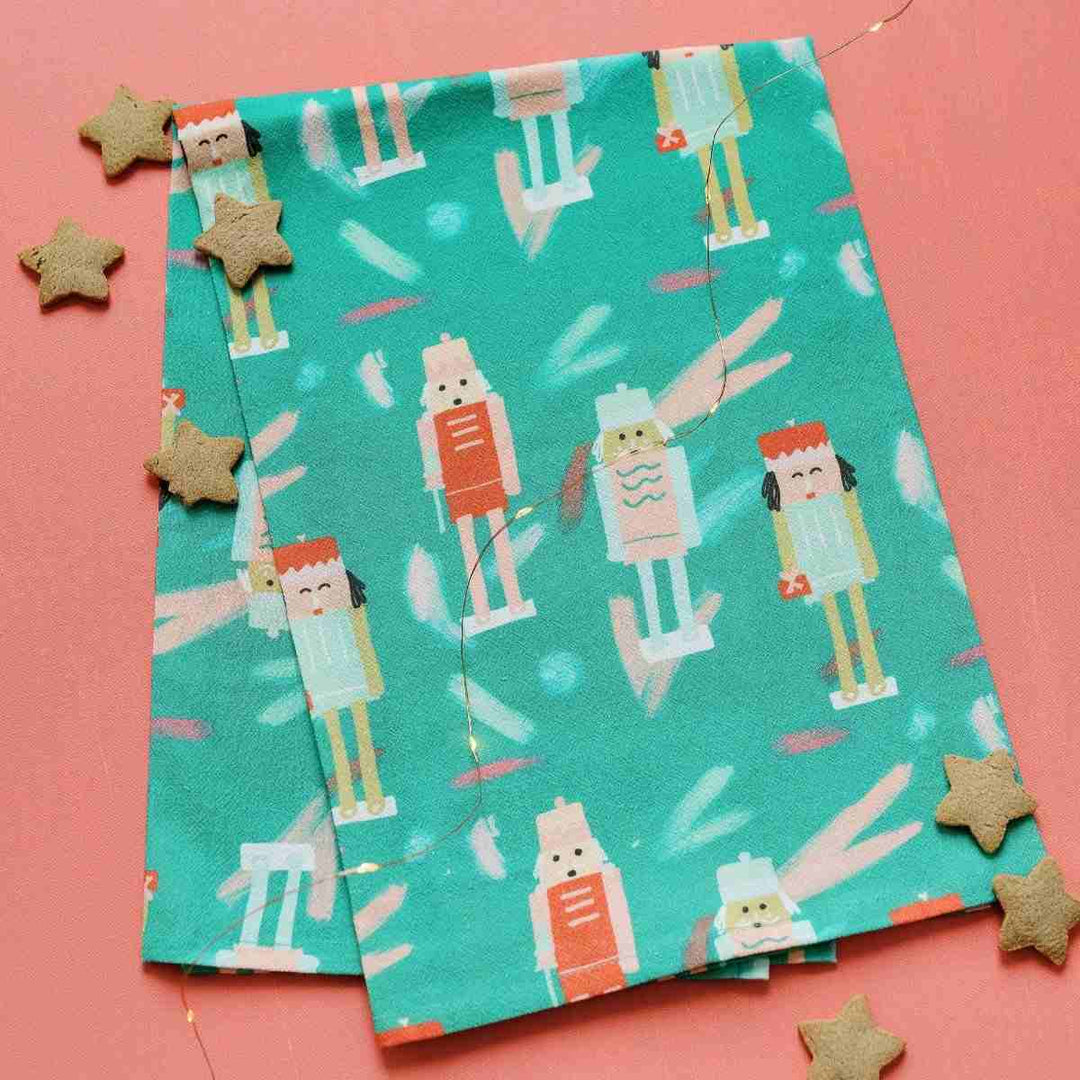 Doe A Deer | Nutcracker | Full Pattern Towel | a mint green towel with a nutcracker figurine pattern.