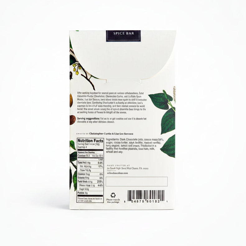 The back of a Spice Bar chocolate bar package, showing the nutrition facts, ingredients list, barcode, and brand information on a white background with botanical illustrations.