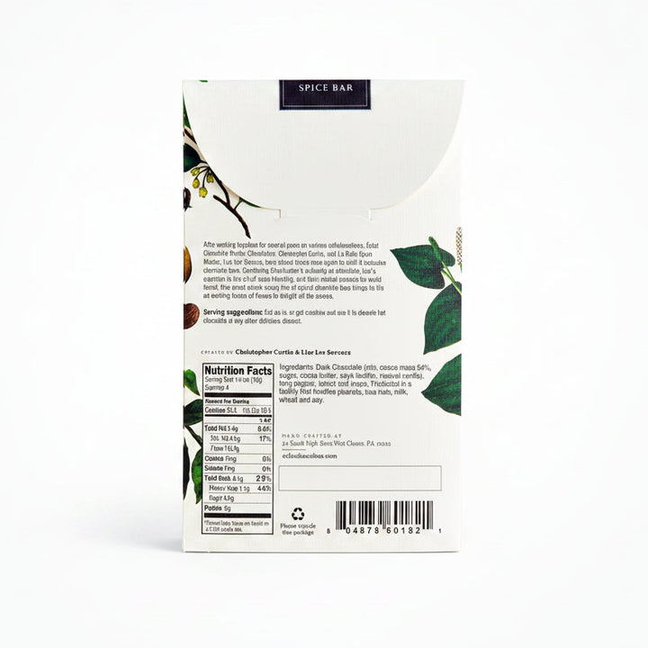 The back of a Spice Bar chocolate bar package, showing the nutrition facts, ingredients list, barcode, and brand information on a white background with botanical illustrations.