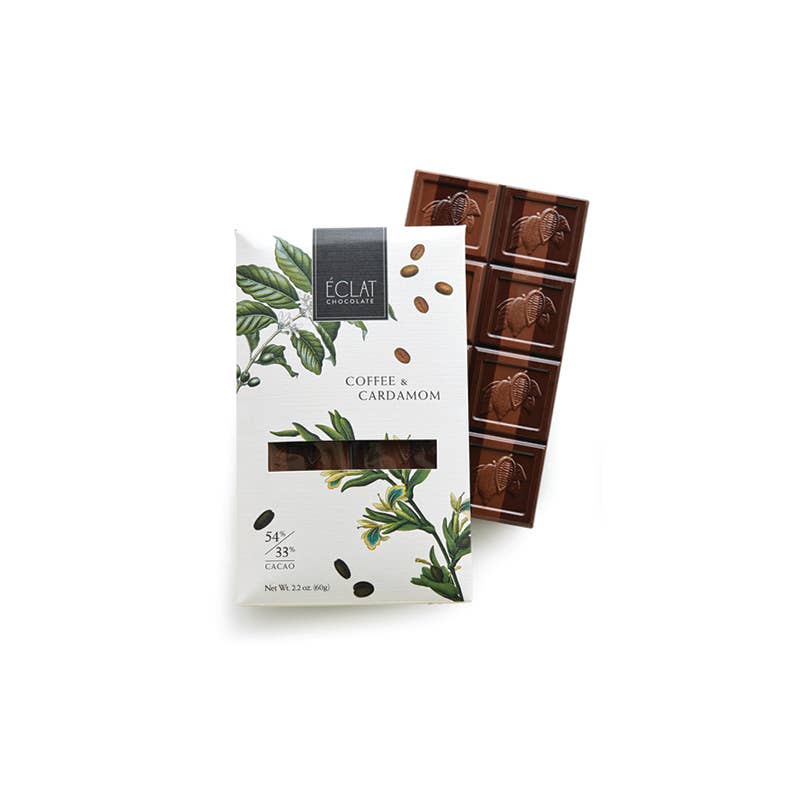 Chocolate bar with packaging featuring botanical design on a white background