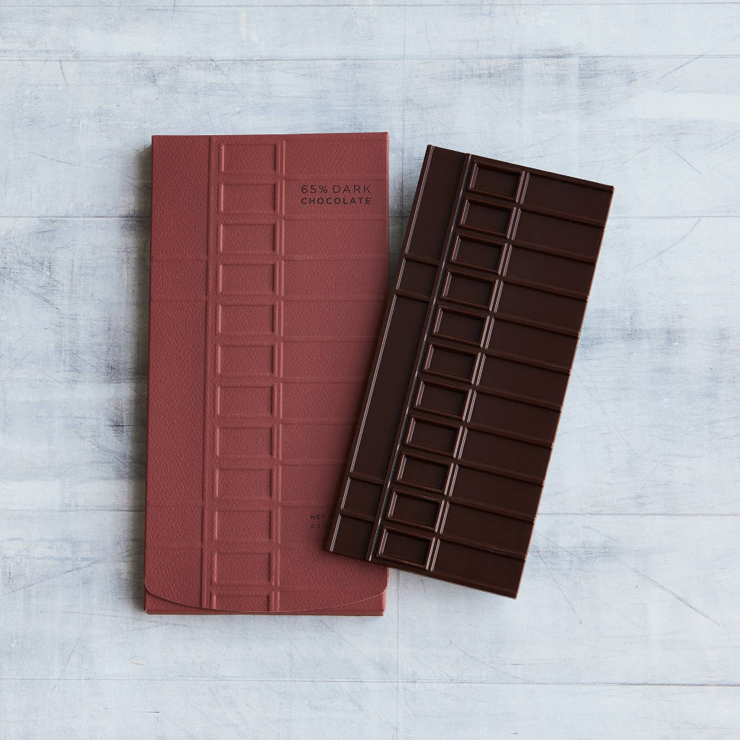 A rectangular notebook in dusty rose pink with embossed vertical lines and the text &
