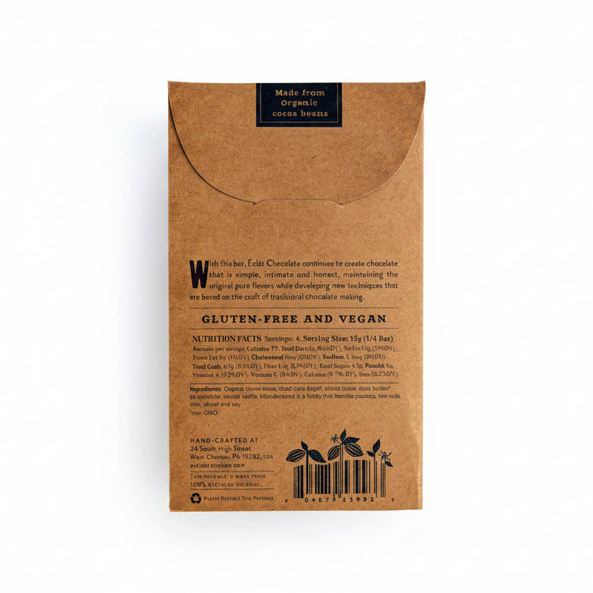 The back of a brown kraft paper chocolate bar package, featuring product information, a barcode, and a small black label at the top that reads &