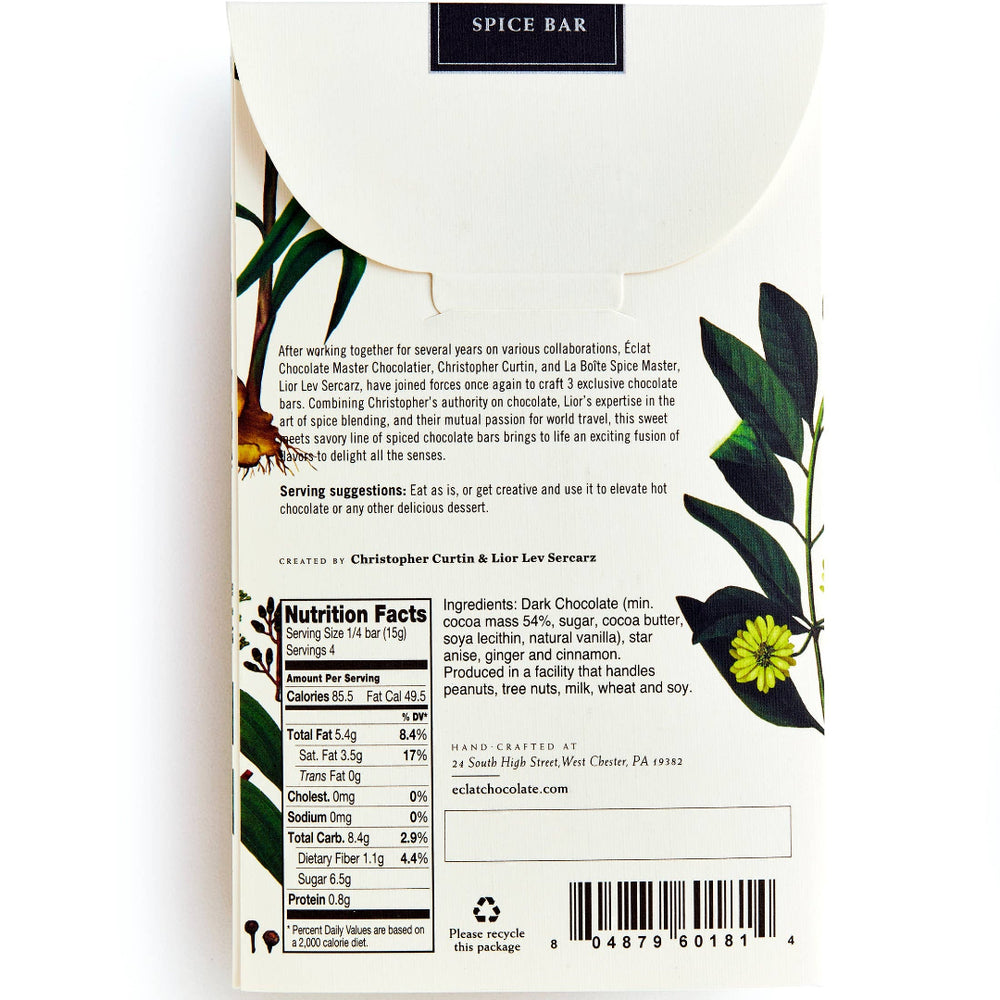 Back of a spice bar package, showing product description, nutrition facts, barcode, and botanical illustrations with green leaves and yellow flowers on a white background.