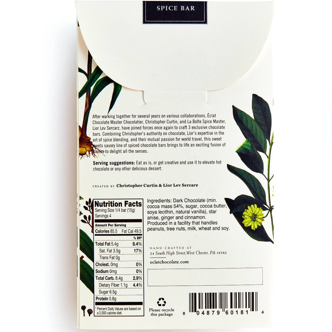 Back of a spice bar package, showing product description, nutrition facts, barcode, and botanical illustrations with green leaves and yellow flowers on a white background.