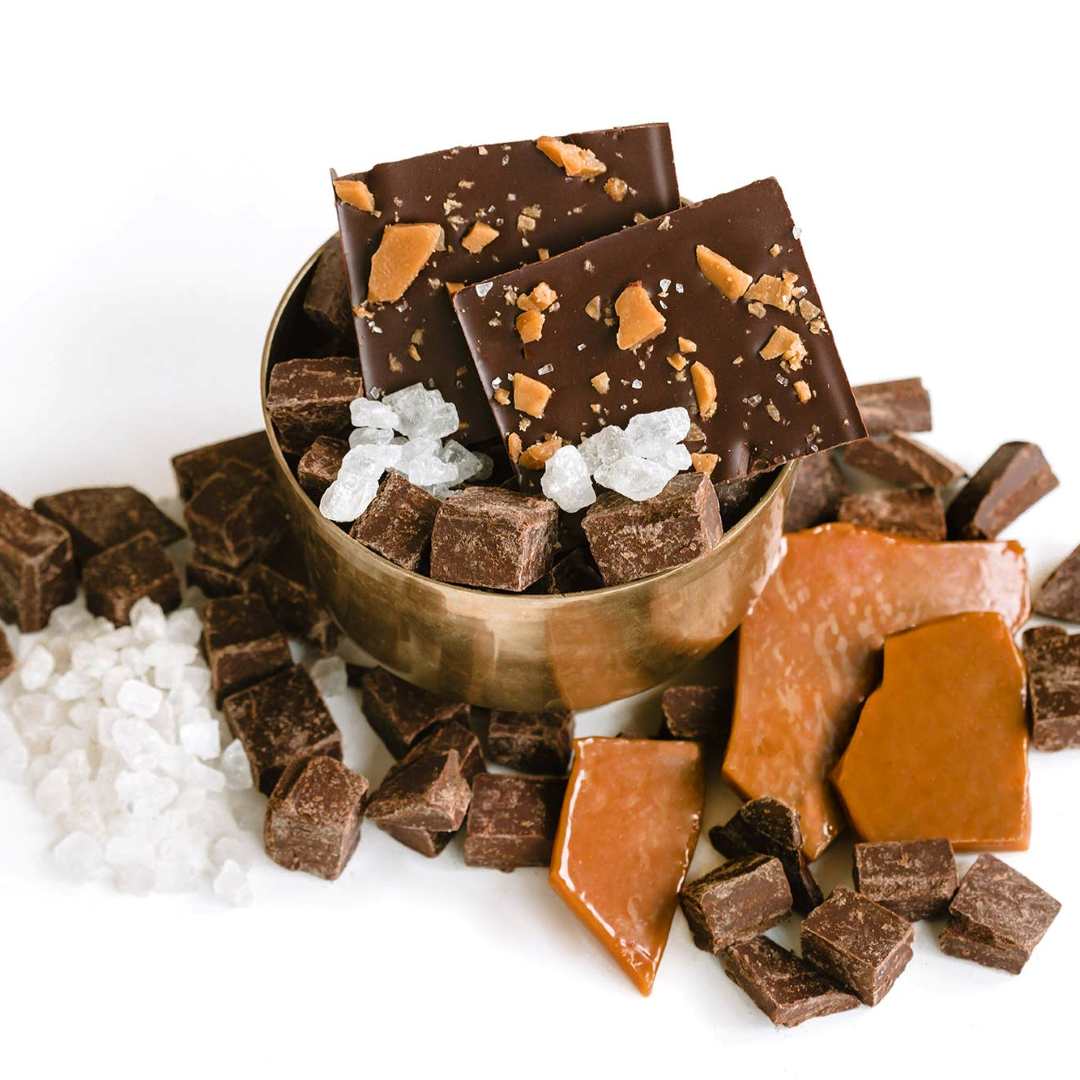 Ethereal Confections | Assorted chocolate pieces in a bowl on a white background