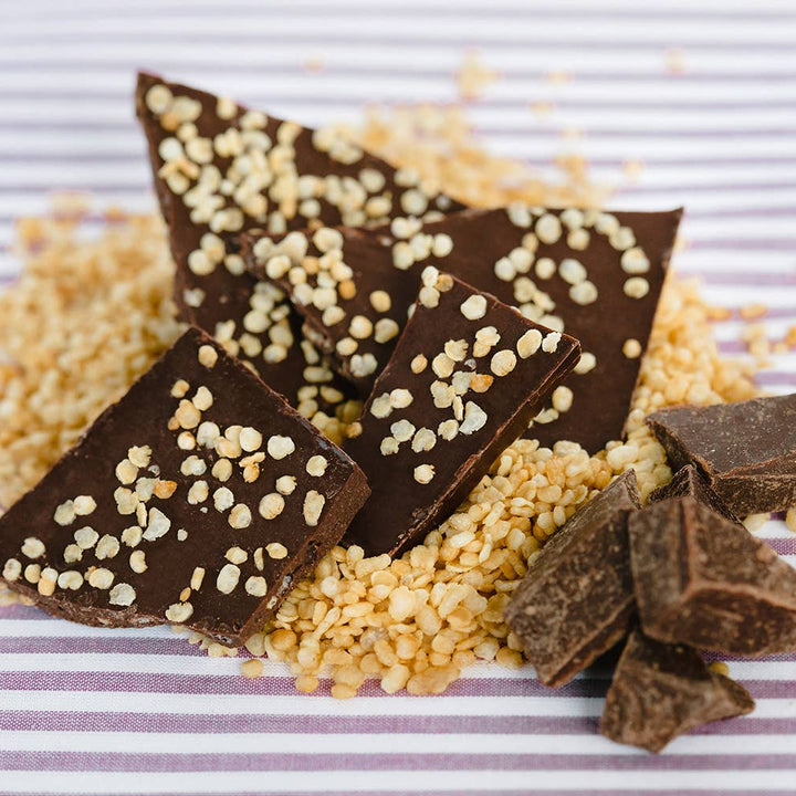 Chocolate pieces with white sprinkles on a striped background