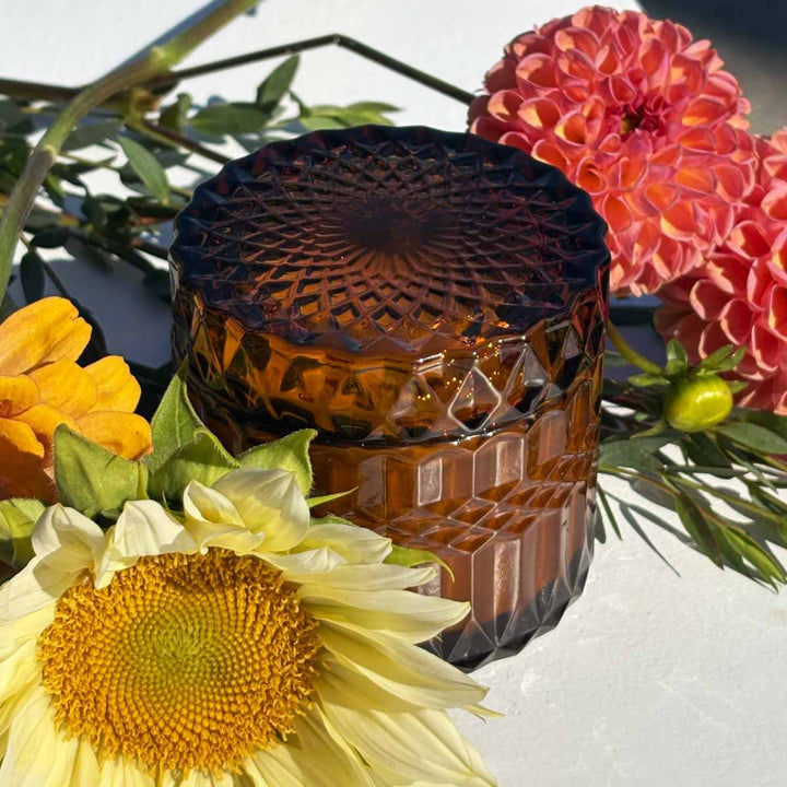 Stacy K Floral | Fleurish Co. | Fall Foliage | Decorative amber glass candle with floral arrangement.