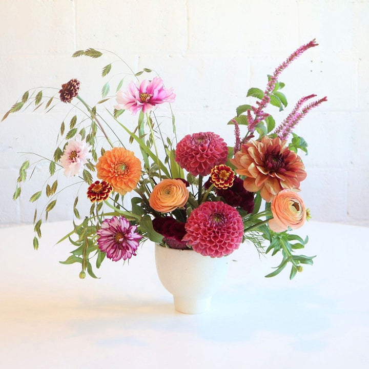 Bountiful | Stacy K Floral | Fresh Floral Arrangement |  A cheery arrangement with bright pinks, peaches, and deep reds. Accented with greenery. Some florals pictured are dahlia, zinnia, and ranunculus.