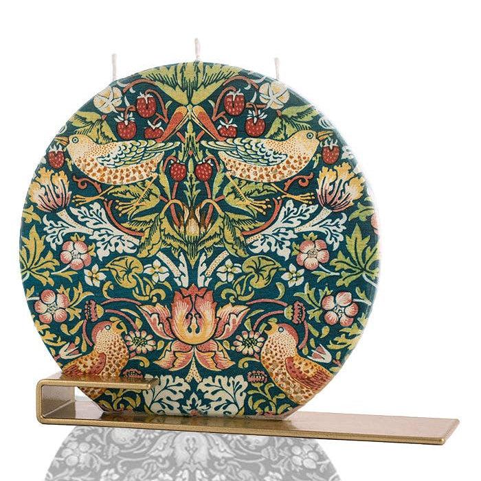 Decorative round plate with intricate floral and bird pattern on a stand against a white background