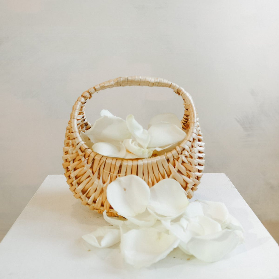 Flower Girl Basket | Stacy K Floral | a wicker basket with fresh floral petals.