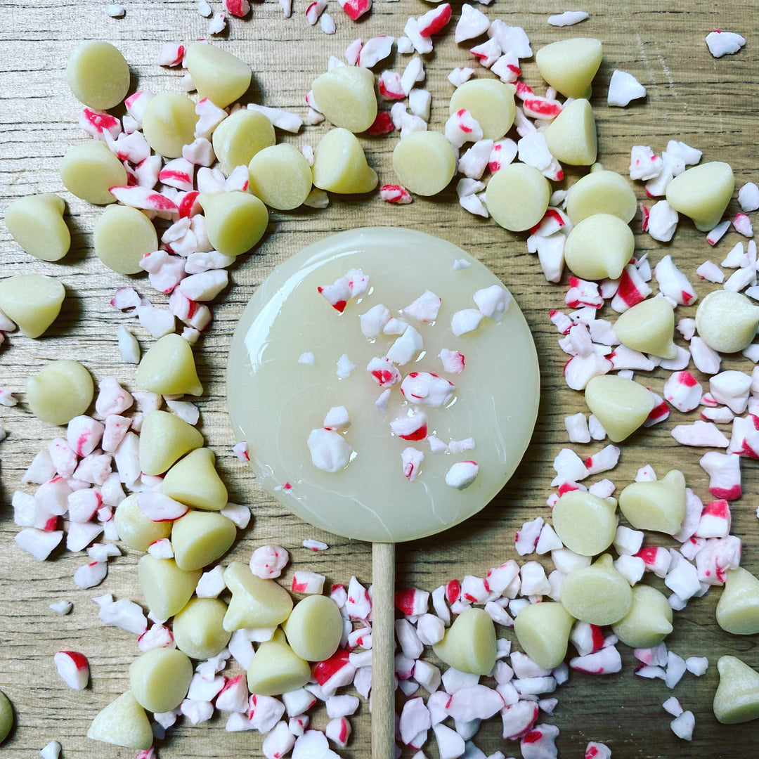 Good Lolli | Peppermint Lollipop | A white lollipop with white chocolate and peppermint pieces.