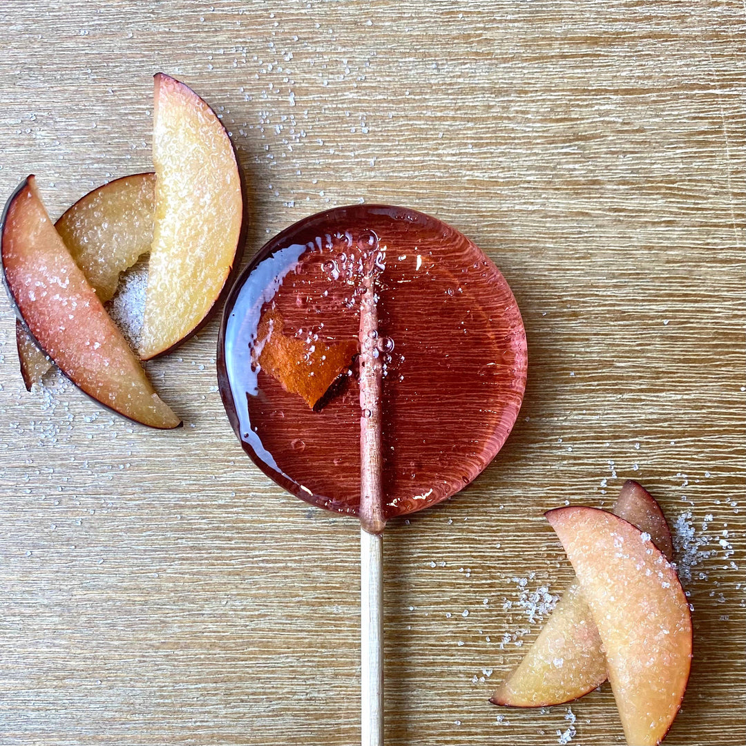 Good Lolli | Sugar Plum Lollipop | Seasonal holiday lollipop with a piece of plum on the interior.