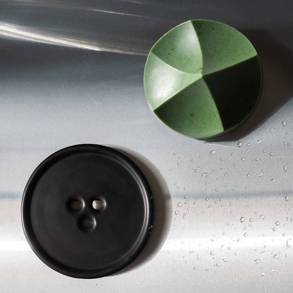 Green and black circular objects on a metallic surface