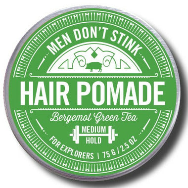Men Don't Stink Hair Pomade | A green tin that reads "men don't stink, hair pomade, bergemot green tea, medium hold, for explorers, 75 g/2.5 oz."