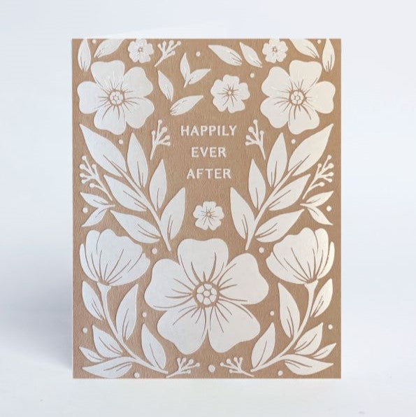 Happily Ever After Greeting Card | A kraft colored card with foiled florals and plants decorating the front. Text reads "Happily Ever After"