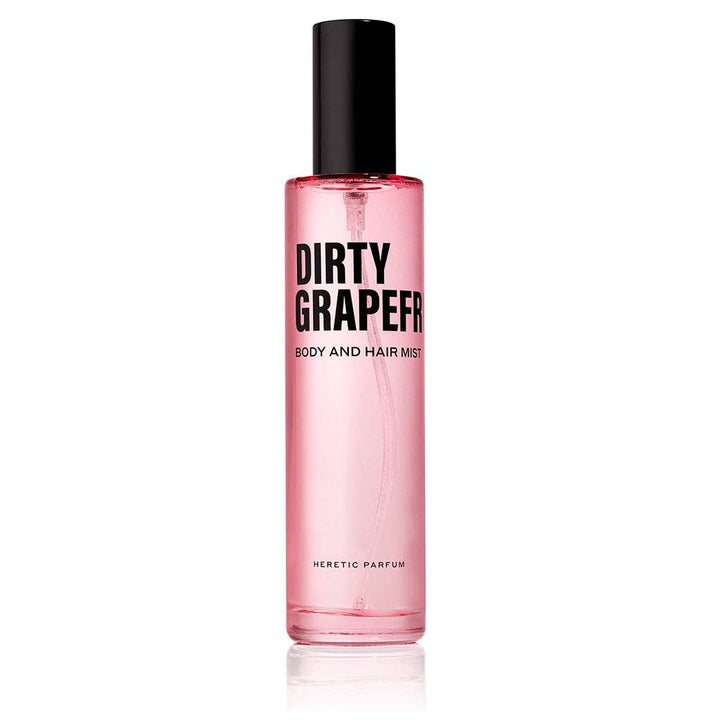 Heretic Parfum | Pink bottle of 'Dirty Grapefruit' body and hair mist on a white background