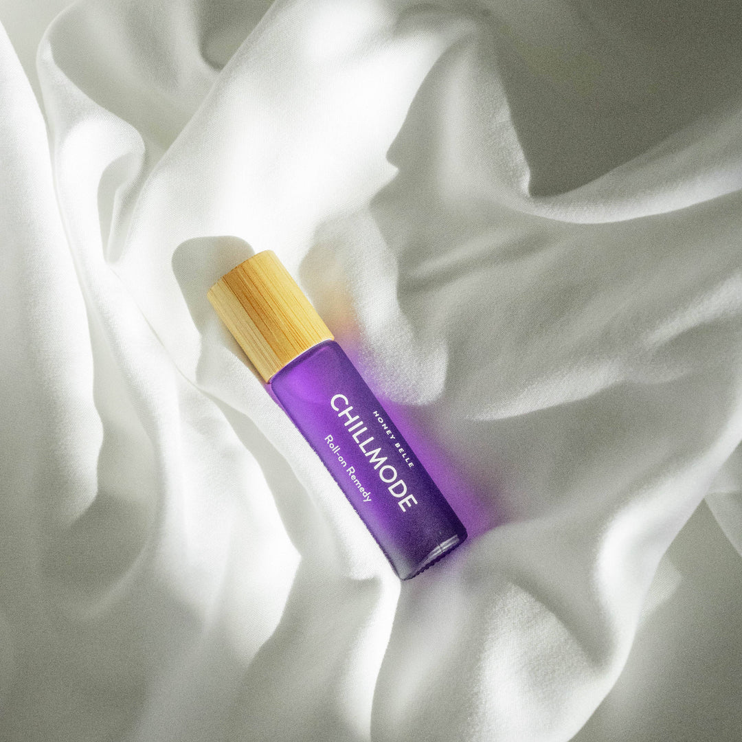 Purple rollerball with wooden top on white fabric