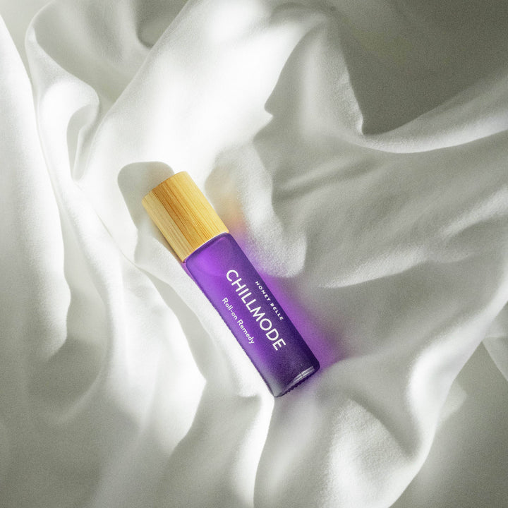 Purple rollerball with wooden top on white fabric
