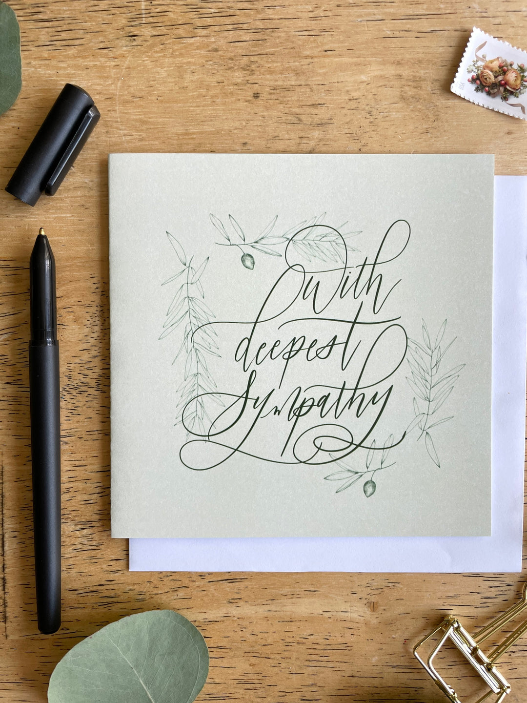 A square green card illustrated with olive greens and 'With Deepest Sympathy’ Greeting Card