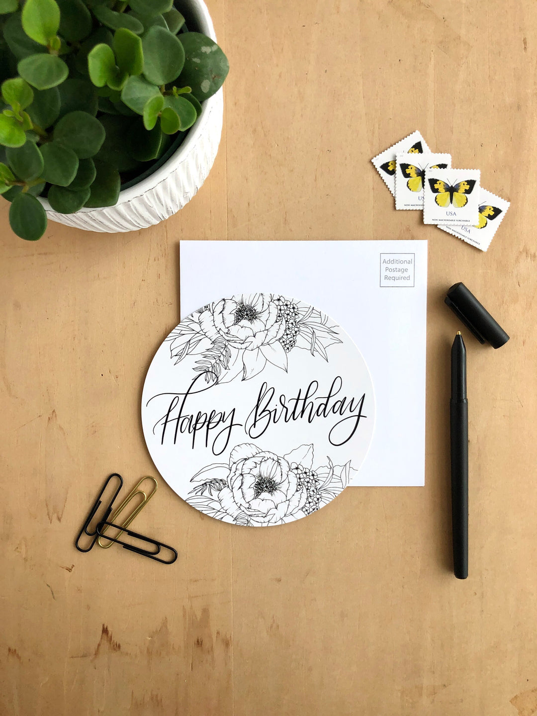 A black and white Happy Birthday Greeting card howcasing illustrations of flowers this floral greeting card captures the essence of a blossoming floral symbolizing growth and the beauty found in relationships.