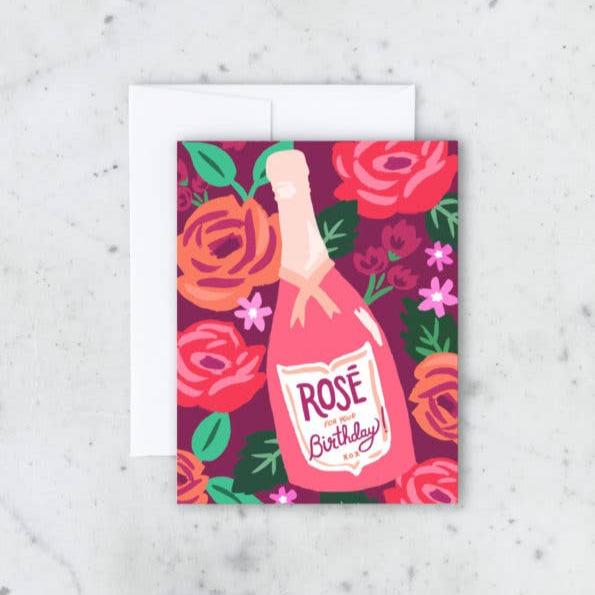 Idlewild Co. | Birthday Rose Card | A pink card with roses and a bottle of rose with a label that reads "Rose for your birthday!".