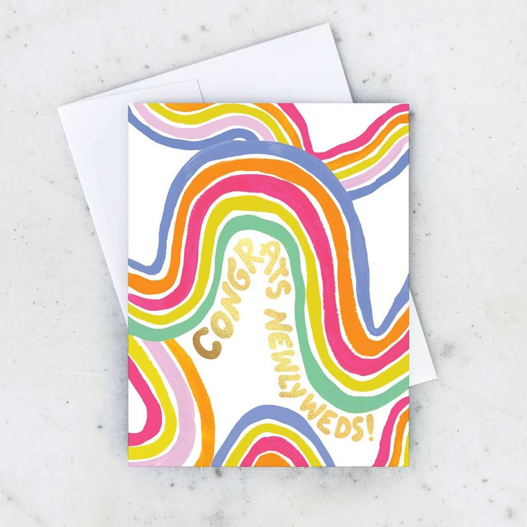 Idlewild Co. | Groovy Newlyweds Card | A rainbow colored card with text that reads "Congrats Newlyweds!".