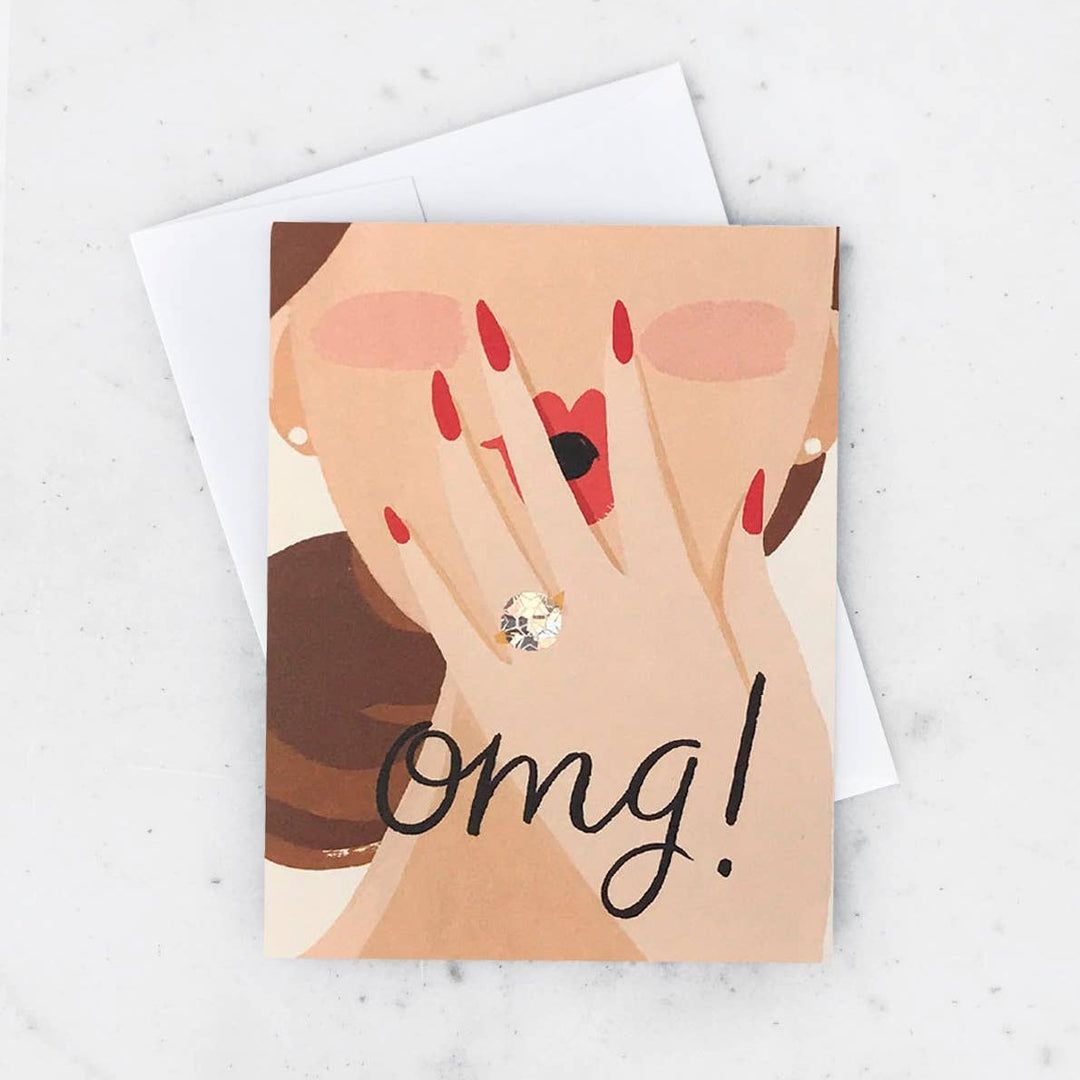 Idlewild Co. | Omg Princess Card | An illustration of a woman covering her surprised face with and engagement ring on her finger. Text "omg!".