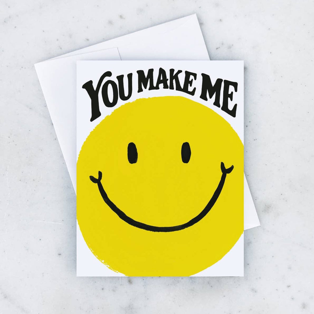 Idlewild Co. | Smile Card | A yellow smiley face card and text that reads "You make me"