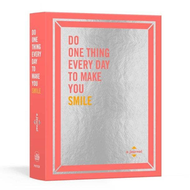 Journal with coral cover and motivational quote on a white background