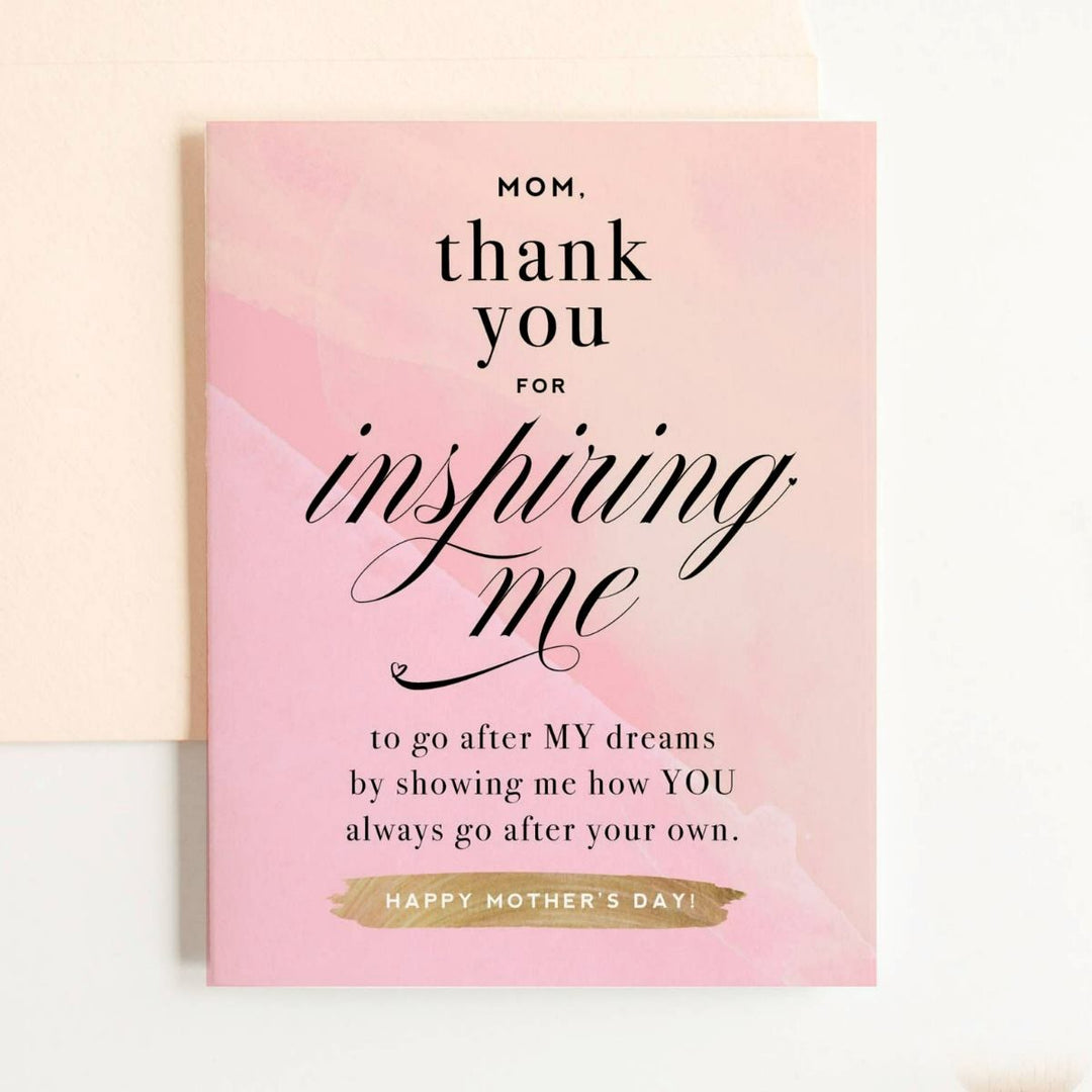 A light pink card with black text that reads "Mom, thank you for inspiring me to go after MY dreams by showing me how YOU always go after your own. Happy Mother's Day!"